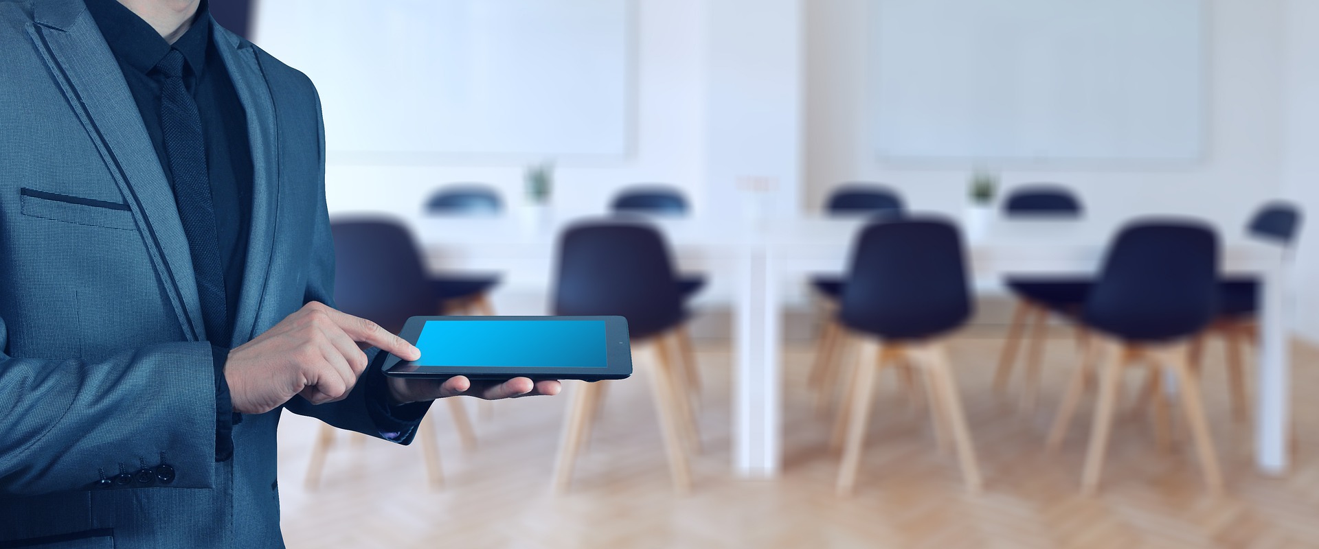 Businessman with iPad in conference room