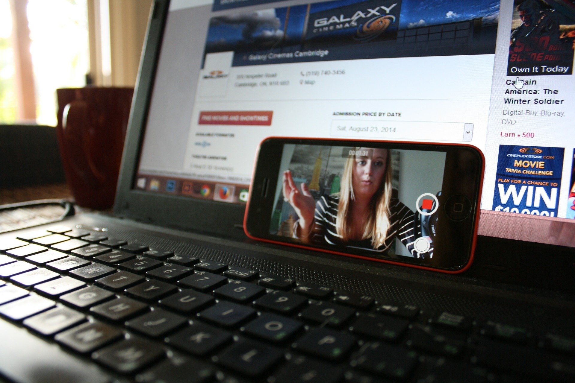 Image of a laptop and phone with video conferencing