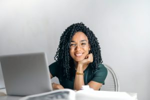 woman smiling behind computer