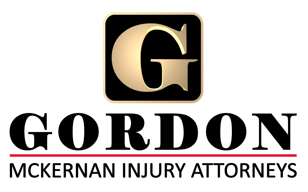 Gordon McKernan's Injury Attorneys' company logo consists of a gold capitalized "G" in a black square that is outlined in the same gold as the G. Underneath it is the black uppercase text "GORDON." Under that is a red horizontal line. Under that is the black capitalized text "MCKERNAN INJURY ATTORNEYS."