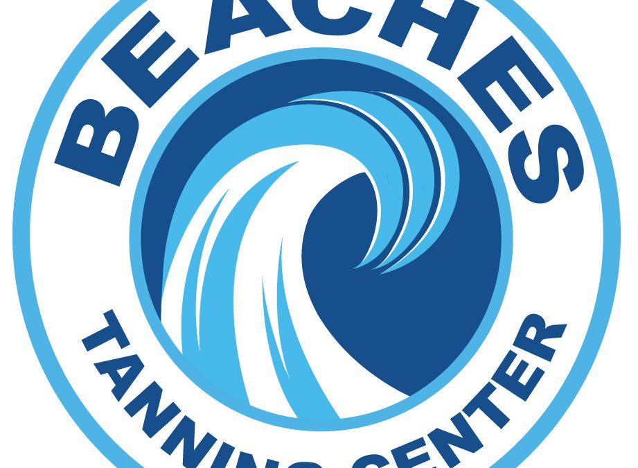 Beaches Tanning Center's company logo consists of the word "BEACHES" and "TANNING CENTER" forming a circular shape. Beaches is above the words TANNING CENTER. Surrounding the words BEACHES TANNING CENTER are two ice blue circles (forming a donut shape." In the center of the "donut" is the picture of a wave that has the colors white and ice blue in it. Behind the wave is a dark blue color. The background of the image is white.