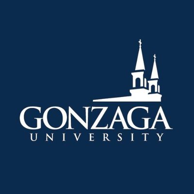 Gonzaga University's school logo consists of a navy blue background with the white text "GONZAGA UNIVERSITY" in the center. Above the "ZAGA" in Gonzaga is the white silhouette of two buildings on a college campus.