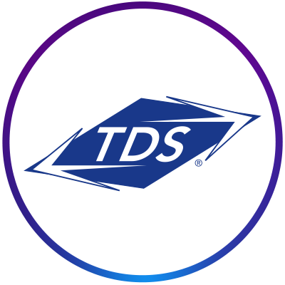 TDS' company logo consists of a white circle with a gradient purple-to-blue ring around it. In the center are the white, capitalized letters, "TDS," on what appears to be a blue rhombus with two white arrows pointing in either direction on two of the corners.