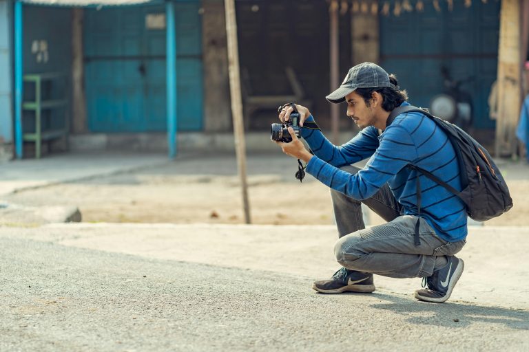 Young photographer taking pictures on the streets of India