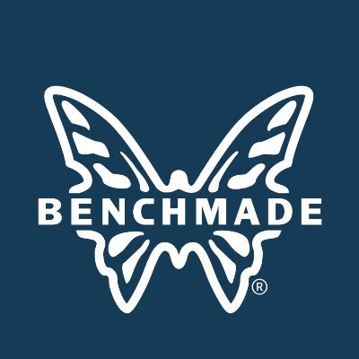 Benchmade's company logo consists of a navy blue background with the drawing of a white butterfly and the horizontal white text "Benchmade" going over the butterfly.