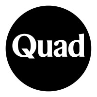 Quad's company logo consists of a black circle with the white text, "Quad," on the inside.
