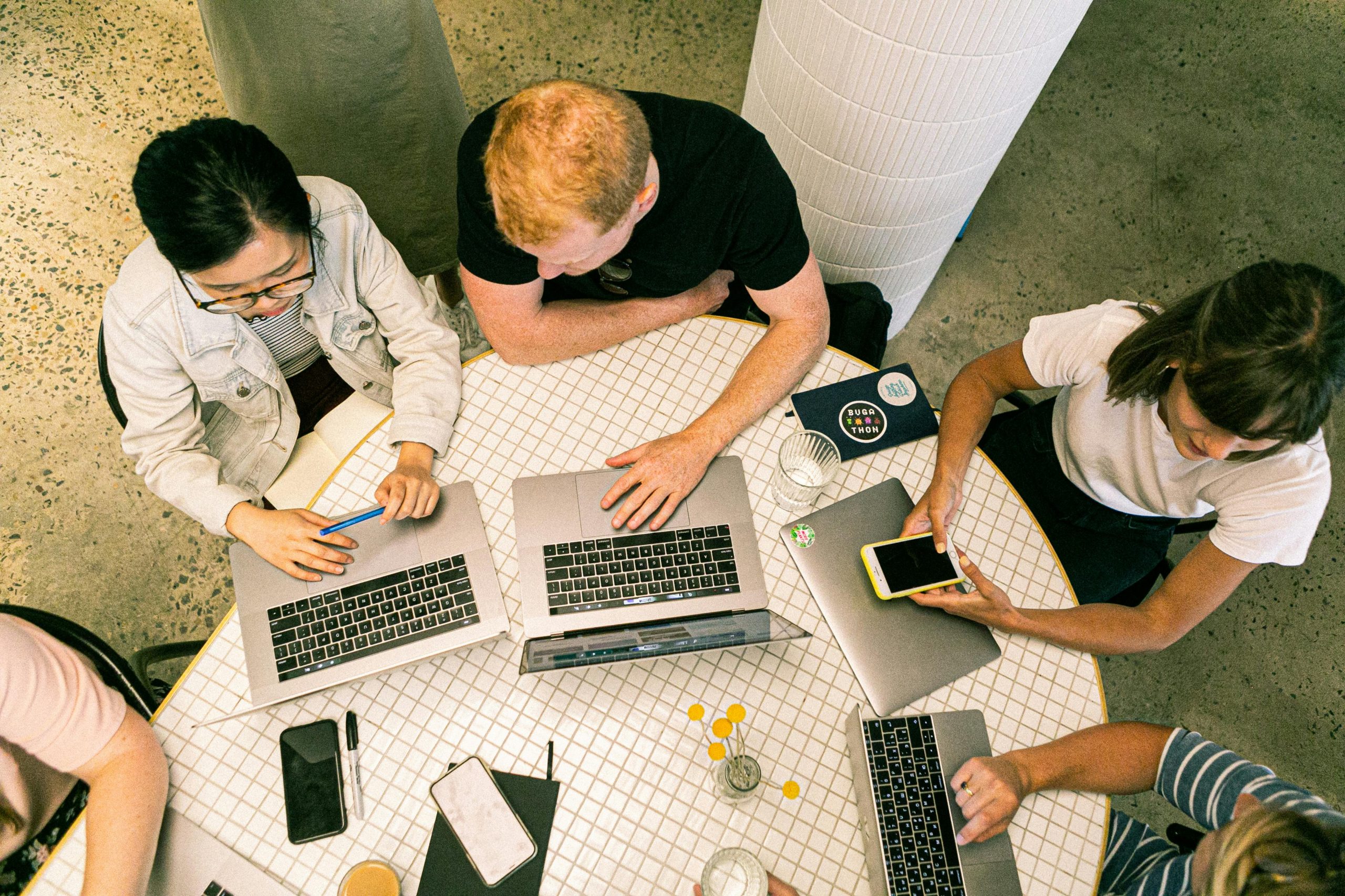 pexels-canvastudio-3194521 Top view of diverse team collaboratively working in a modern office setting.
