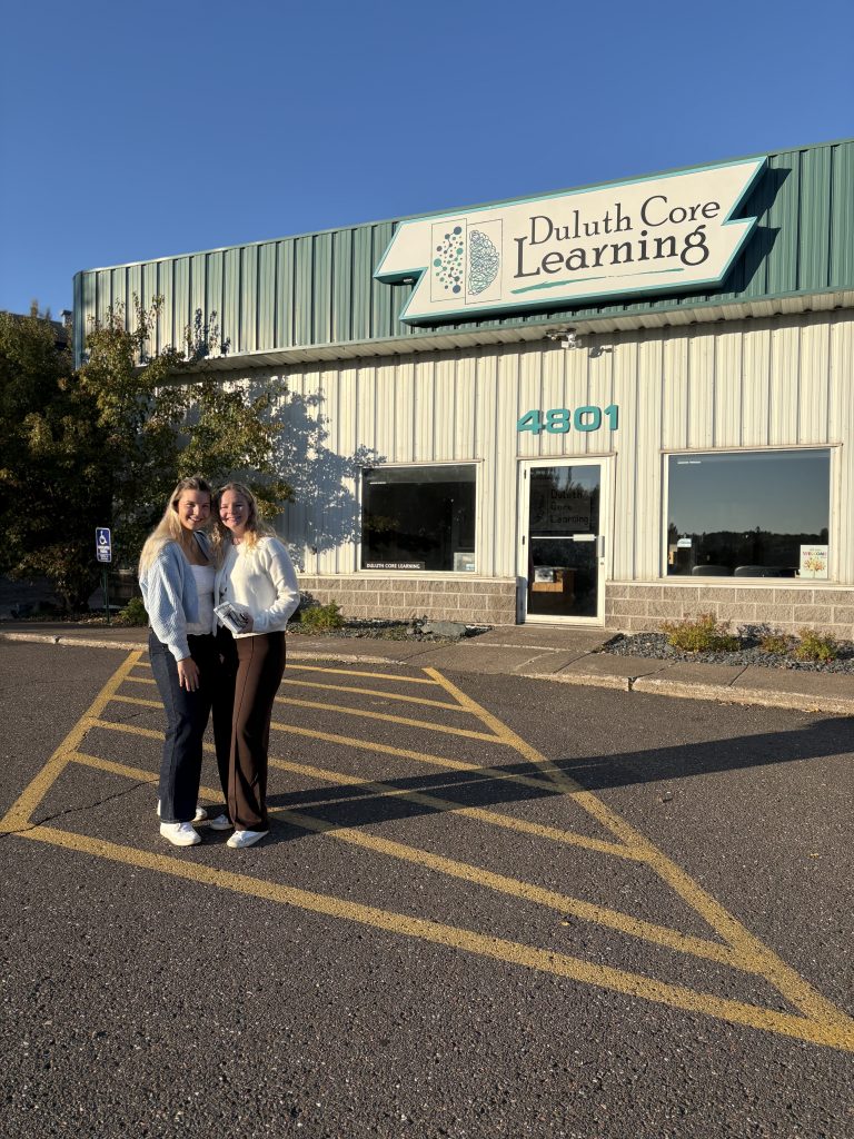 Saints Agency team standing outside of Duluthe Cor