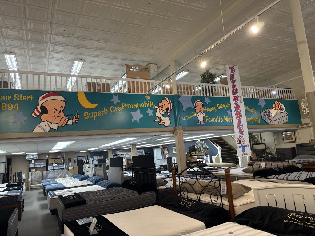 Inside of Happy Sleeper Mattress, showcasing the store's mattresses.